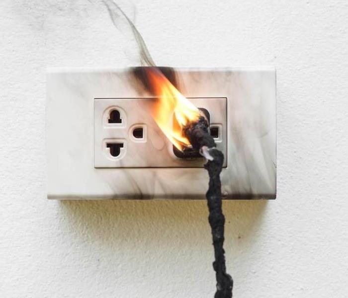 A fire breaking out from a wall outlet.